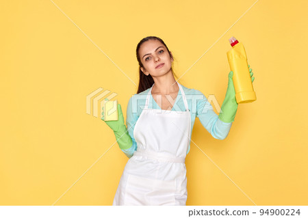 woman in gloves and cleaner apron cleaning with yellow sponge 94900224