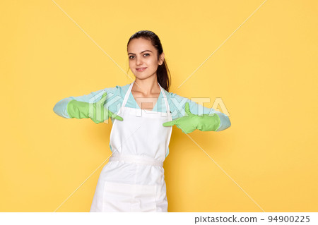 smiling caucasian woman in gloves pointing oneself with fingers 94900225