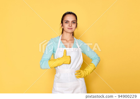 woman in gloves and cleaner apron showing ok sign woman in gloves and cleaner apron showing ok sign 94900229
