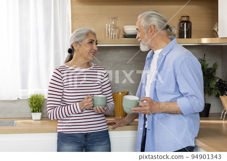 Home Leisure. Portrait Of Smiling Senior Spouses Drinking Coffee In Kitchen Interior Home Leisure. Portrait Of Smiling Senior Spouses Drinking Coffee In Kitchen Interior 94901343