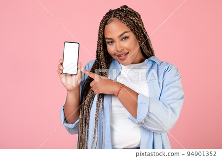 Cheerful African American Woman Showing Cellphone Over Pink Background Cheerful African American Woman Showing Cellphone Over Pink Background 94901352