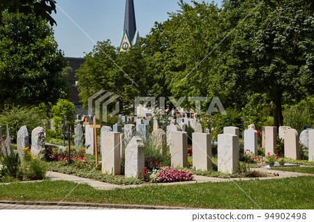 Graveyard with tombstones by a church 94902498