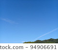 Blue sky, contrails and mountains 94906691
