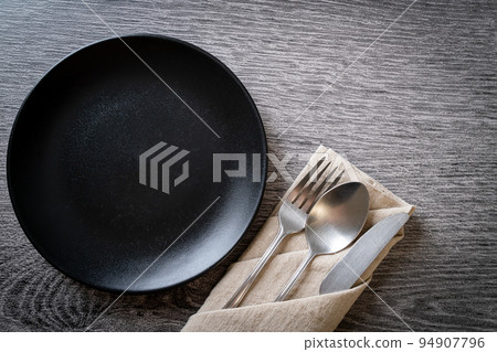 empty plate or dish with knife, fork and spoon 94907796