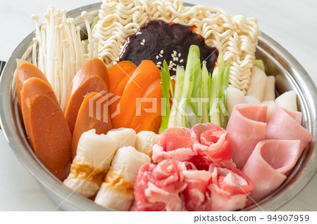Budae Jjigae or Budaejjigae (Army stew or Army base stew). It is loaded with Kimchi, spam, sausages, ramen noodles and much more Budae Jjigae or Budaejjigae (Army stew or Army base stew). It is loaded with Kimchi, spam, sausages, ramen noodles and much more 94907959