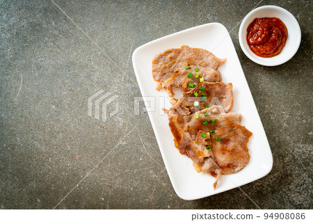 grilled pork neck sliced on plate 94908086