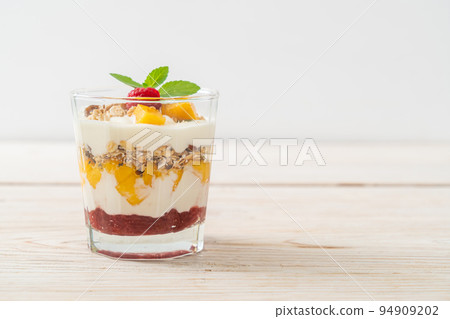homemade mango and raspberry with yogurt and granola 94909202