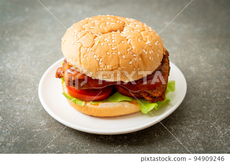 grilled chicken burger with sauce on plate 94909246