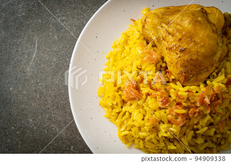 Chicken Biryani or Curried rice and chicken - Thai-Muslim version of Indian biryani, with fragrant yellow rice and chicken Chicken Biryani or Curried rice and chicken - Thai-Muslim version of Indian biryani, with fragrant yellow rice and chicken 94909338