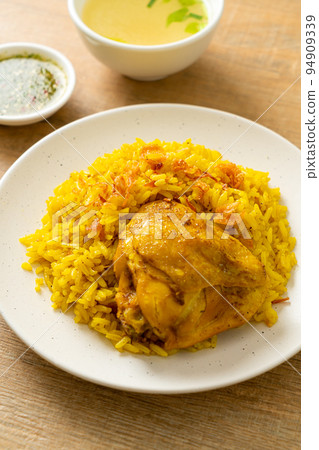 Chicken Biryani or Curried rice and chicken - Thai-Muslim version of Indian biryani, with fragrant yellow rice and chicken Chicken Biryani or Curried rice and chicken - Thai-Muslim version of Indian biryani, with fragrant yellow rice and chicken 94909339