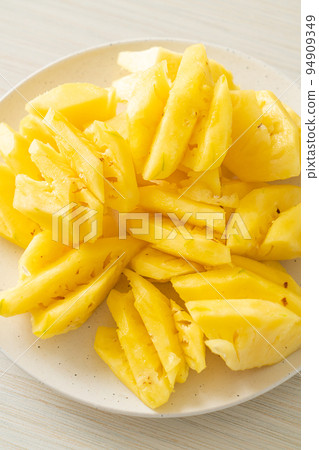fresh pineapple sliced on plate fresh pineapple sliced on plate 94909349