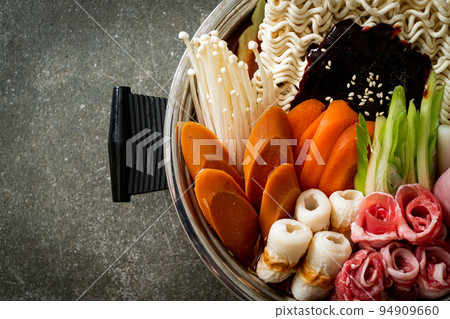 Budae Jjigae or Budaejjigae (Army stew or Army base stew). It is loaded with Kimchi, spam, sausages, ramen noodles and much more Budae Jjigae or Budaejjigae (Army stew or Army base stew). It is loaded with Kimchi, spam, sausages, ramen noodles and much more 94909660