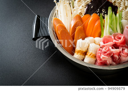 Budae Jjigae or Budaejjigae (Army stew or Army base stew). It is loaded with Kimchi, spam, sausages, ramen noodles and much more 94909879