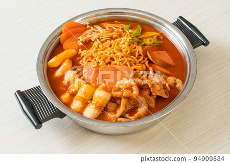 Budae Jjigae or Budaejjigae (Army stew or Army base stew). It is loaded with Kimchi, spam, sausages, ramen noodles and much more 94909884