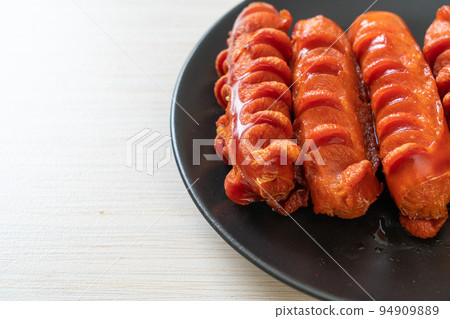deep fried sausage skewer on plate 94909889