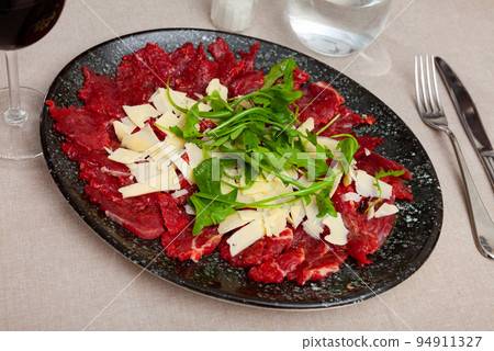 Raw beef meat, carpaccio, served on plate Raw beef meat, carpaccio, served on plate 94911327