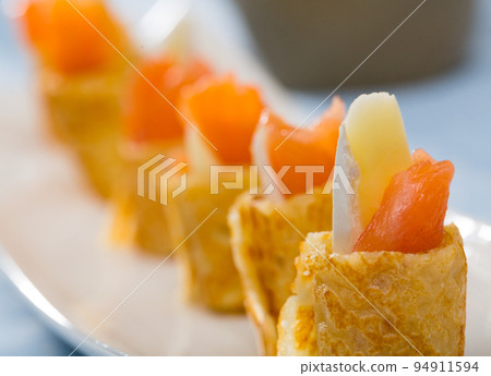 Pancakes rolls with salted salmon on a plate Pancakes rolls with salted salmon on a plate 94911594