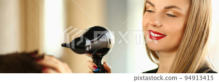 Woman hairdresser doing styling with hairdryer to man 94913415