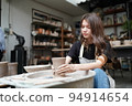 Beautiful woman making ceramic pottery on wheel, close-up. woman in freelance, business, hobby. 94914654