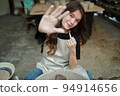 Beautiful woman making ceramic pottery on wheel, close-up. woman in freelance, business, hobby. 94914656