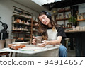 Beautiful woman making ceramic pottery on wheel, close-up. woman in freelance, business, hobby. 94914657