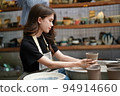Beautiful woman making ceramic pottery on wheel, close-up. woman in freelance, business, hobby. 94914660