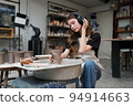 Beautiful woman making ceramic pottery on wheel, close-up. woman in freelance, business, hobby. 94914663