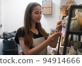 Beautiful woman making ceramic pottery on wheel, close-up. woman in freelance, business, hobby. 94914666