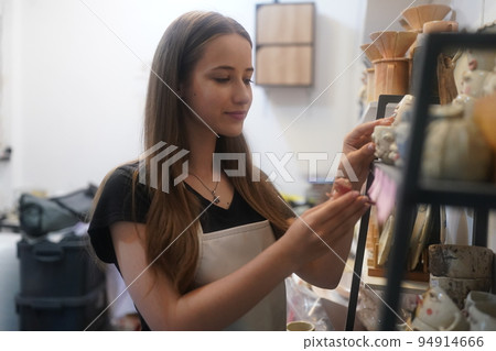 Beautiful woman making ceramic pottery on wheel, close-up. woman in freelance, business, hobby. Beautiful woman making ceramic pottery on wheel, close-up. woman in freelance, business, hobby. 94914666