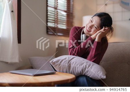 Young asian woman happy life sitting on couch cozy living room at home. The house was homely concept Young asian woman happy life sitting on couch cozy living room at home. The house was homely concept 94914765