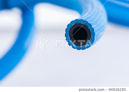 Close-up oxygen hose for industrial application on gray metal background Close-up oxygen hose for industrial application on gray metal background 94916295