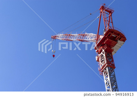 Tower crane towering over the construction site Tower crane towering over the construction site 94916913