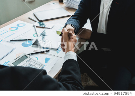 Businessman handshake for teamwork of business merger and acquisition,successful negotiate, two businessman shake hand with partner to celebration partnership and business deal concept. 94917894
