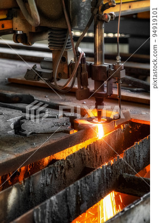 CNC machine cutting the metal plate in workroom by factory. The hi-technology sheet metal manufacturing process 94919101