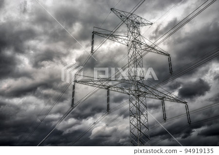 High voltage pole and dark clouds on sky High voltage pole and dark clouds on sky 94919135