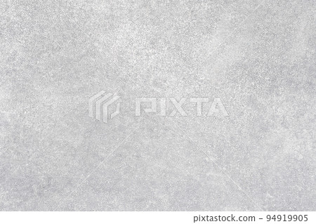 Concrete background. Spotted wall. Light surface. Textured grain cementum with small stones covering white paint copy space for text logo. 94919905