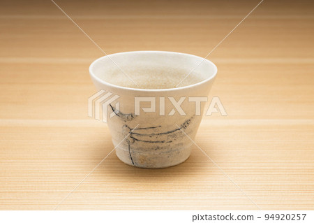 Buckwheat sake cup with wood grain background 94920257