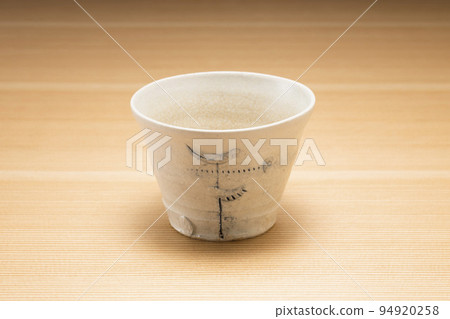 Buckwheat sake cup with wood grain background 94920258