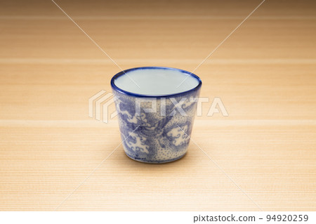 Buckwheat sake cup with wood grain background 94920259