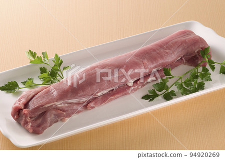 A chunk of pork tenderloin served in a white bowl A chunk of pork tenderloin served in a white bowl 94920269