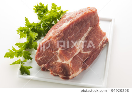 A chunk of pork shoulder loin served in a bowl 94920298