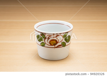 Buckwheat sake cup with wood grain background Buckwheat sake cup with wood grain background 94920326
