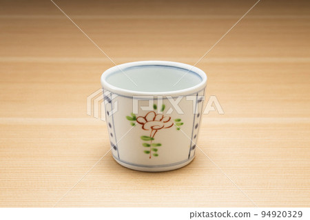 Buckwheat sake cup with wood grain background 94920329