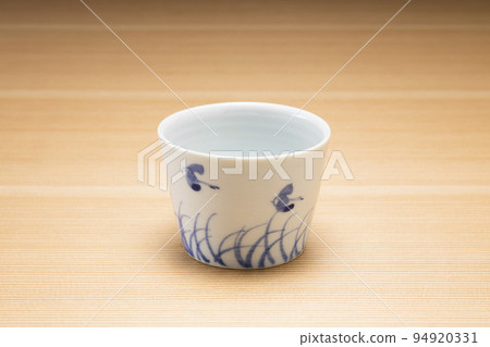 Buckwheat sake cup with wood grain background 94920331
