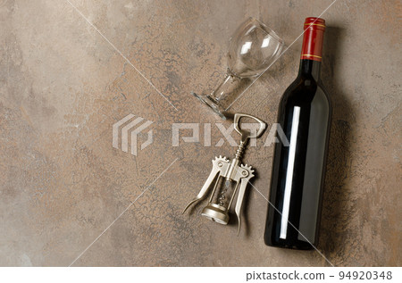Red wine in a bottle. Brown concrete background. Flat lay. Copy space. Red wine in a bottle. Brown concrete background. Flat lay. Copy space. 94920348