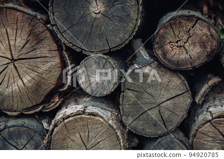 Aged balks. Wooden background. Rustic style. Old rough pile of tree bars different size with cracks and gaps copy space. 94920785