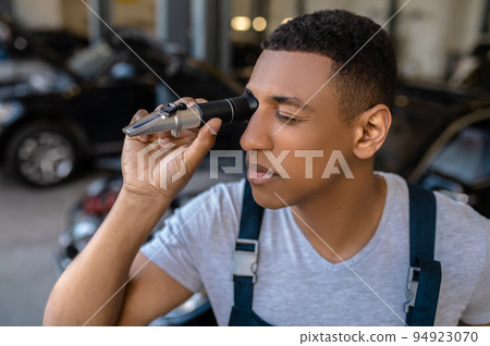 Automotive technician working at the car service station 94923070
