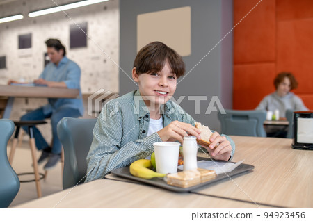 Pupil having lunch in the school canteen Pupil having lunch in the school canteen 94923456