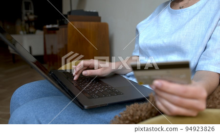 Laptop and credit card in hands. Shopping online from home, safe payment and mobile device 94923826