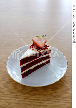 pieces of red velvet cake,tree layer with cream cheese frosting on white dish.Homemade bakery concept.. 94924106